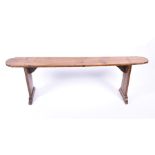 An 18th / 19th century provincial French oak side bench supported on two bar feet, 150 cm long, 50