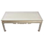 A 20th century French green painted coffee table the top painted with floral motifs and a broad