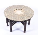 A 20th century Benares brass tray topped table the shaped circular top with scrolling foliate