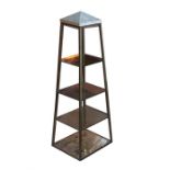 A contemporary brass, stone and glass display pedestal the three square glass shelves supported on
