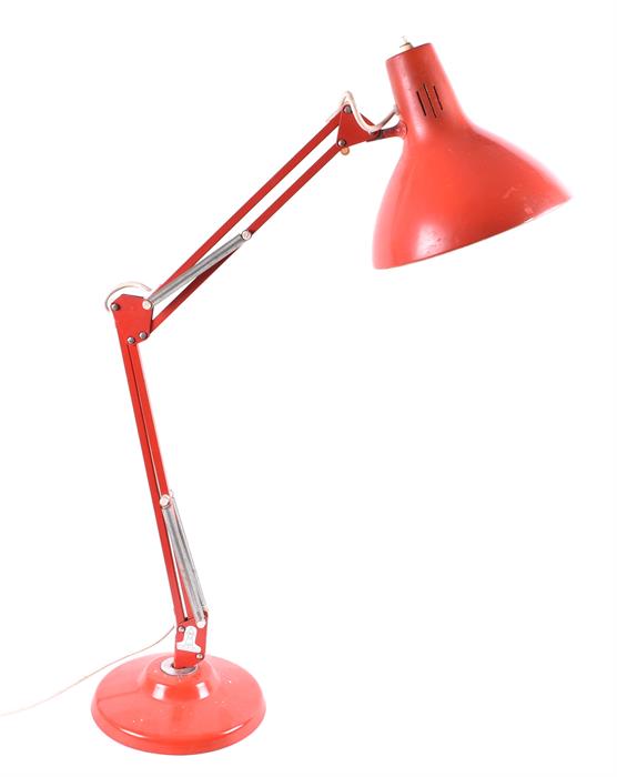 A 1970s Anglepoise-style sprung and angular desk lamp finished in red, with weighted base, the