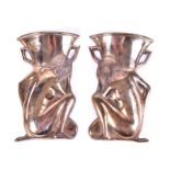 A pair of brass/copper Art Deco wall pockets  in the form of a nude figure crouching beside a