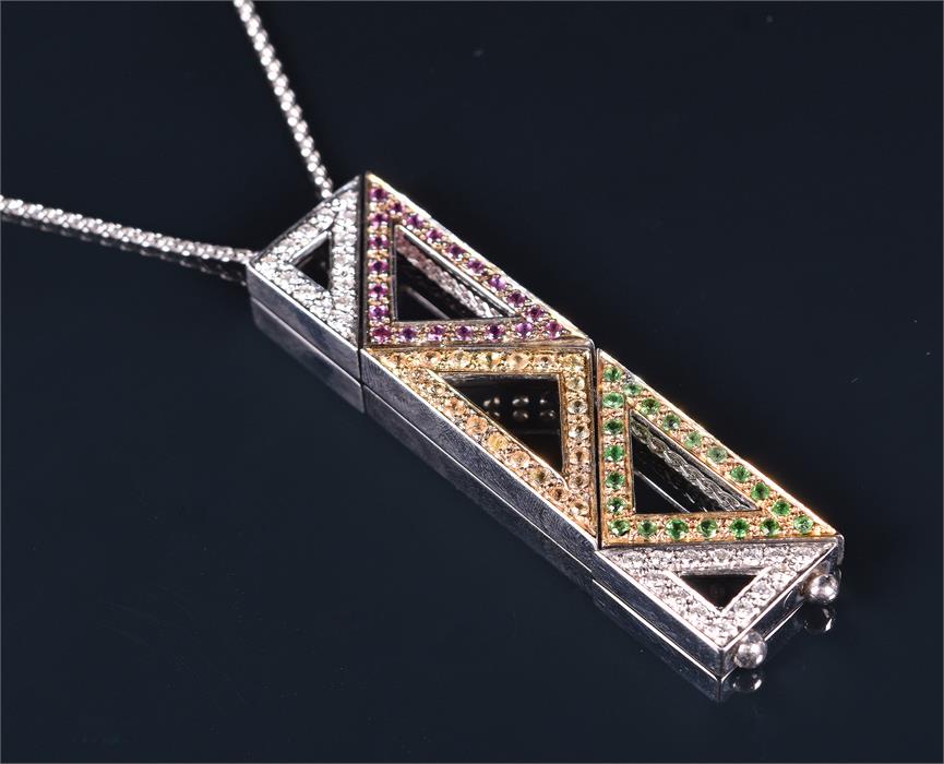 An unusual 18ct white gold, diamond, pink and yellow sapphire, and demantoid garnet pendant of