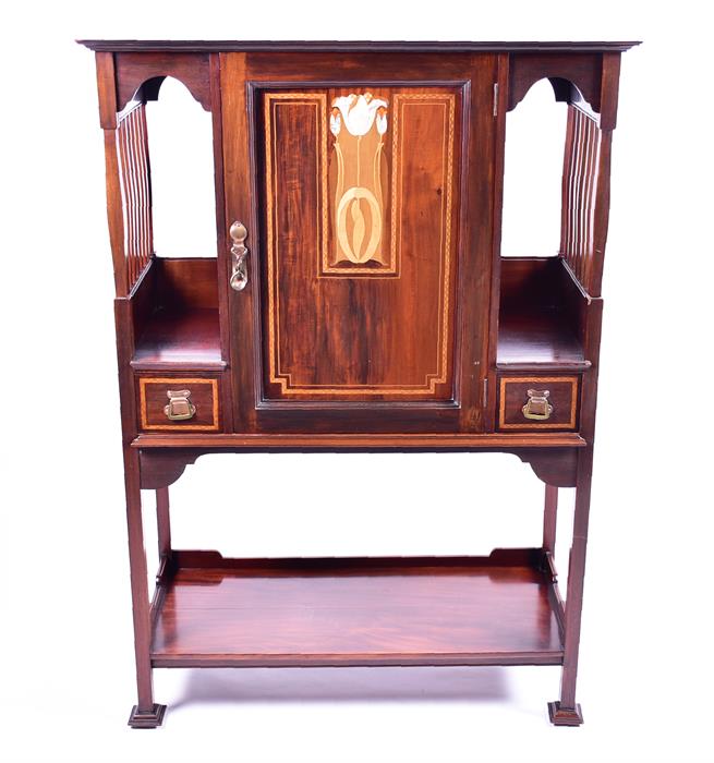 An Art Nouveau mahogany music cabinet the panel door inlaid with mother-of-pearl, opening to