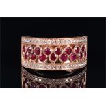 An 18ct rose gold, diamond, and ruby ring the half eternity openwork band set with sixteen round-cut