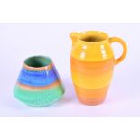 Two pieces of Shelley pottery comprising a tall yellow striped water jug and a drip glazed pot in