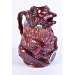 A Victorian majolica glazed novelty jug in the form of a seated bear with open mouth to spout,