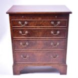 A small 20th century figured walnut bachelors chest the cross-banded top with brushing slide over