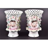 A pair of late 18th century Derby vases of footed and reticulated form  decorated with flowers, a