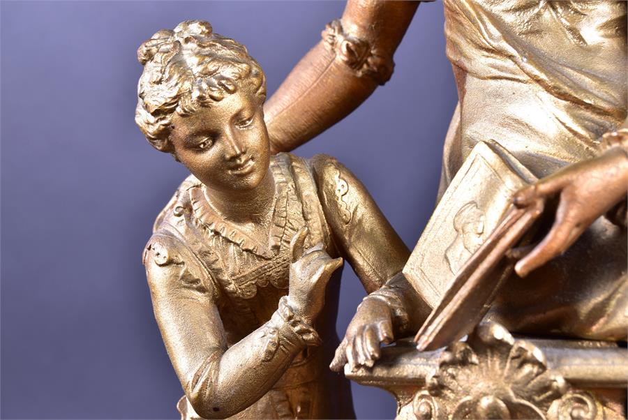 A late 19th century French spelter mantel clock formed as a woman and child reading a book, upon a - Image 4 of 9