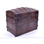A large 19th century metal bound domed top trunk the rising lid with fitted interior and lift-out