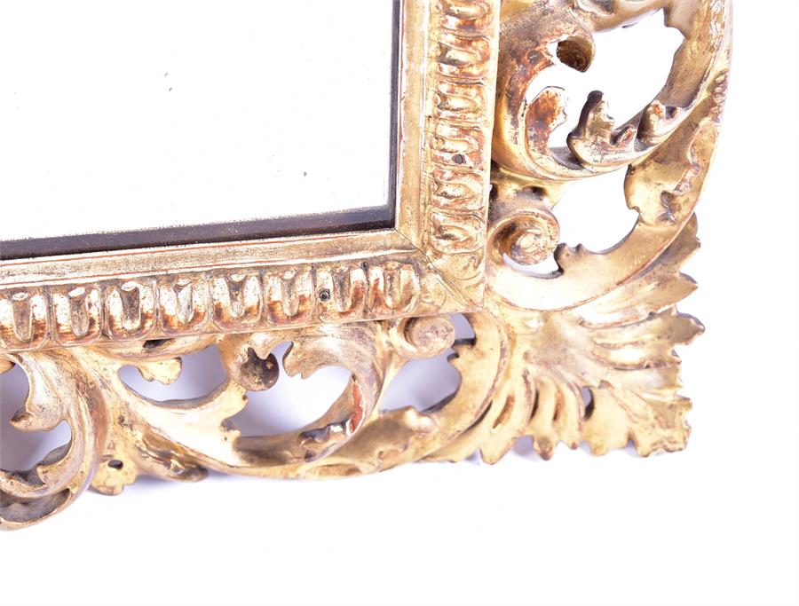 A 19th century wall mirror set within a cut gilt wooden frame with scrolling pierced acanthus cut - Image 3 of 4