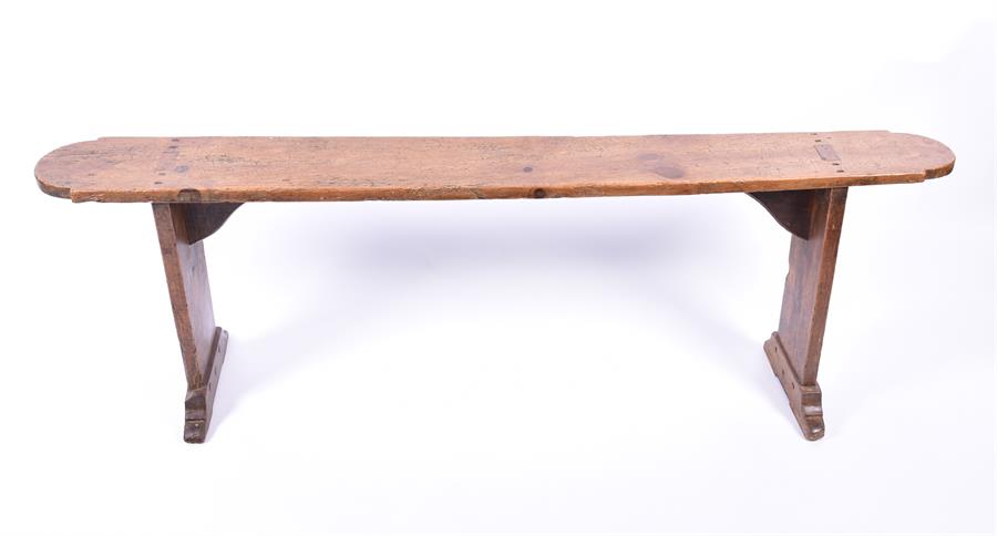 An 18th / 19th century provincial French oak side bench supported on two bar feet, 150 cm long, 50