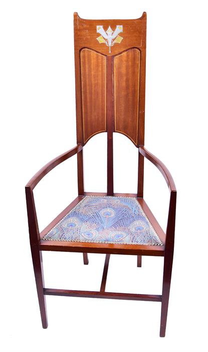 An Art Nouveau mahogany high back armchair in the style of Mackintosh, with inlaid device to the top