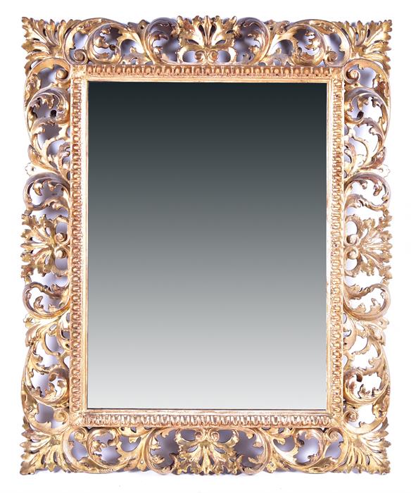 A 19th century wall mirror set within a cut gilt wooden frame with scrolling pierced acanthus cut