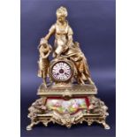 A late 19th century French spelter mantel clock formed as a woman and child reading a book, upon a