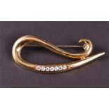 An 18ct yellow gold and cubic zirconia set brooch of swirled form, 4.3 cm long, 6.5 grams.