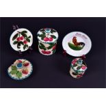 A Wemyss lidded preserve jar and others the jar hand painted with cherries set within shaped green