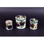 A Wemyss lidded biscuit barrel, preserve jar and a further jar (missing lid) all decorated with hand