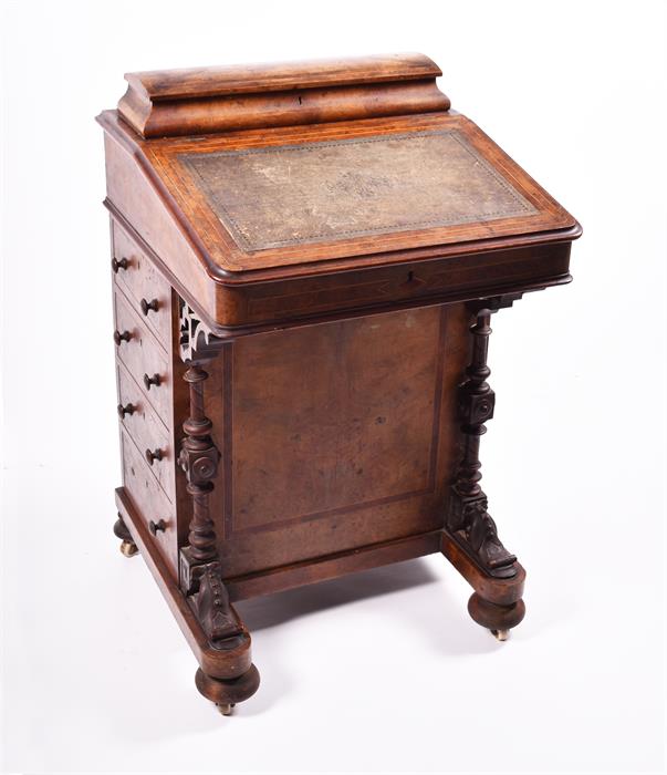 A Victorian figured walnut Davenport the top with stationery compartment, and rising writing surface