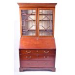 A George III mahogany bureau bookcase the top with a pair of astragal glazed doors enclosing