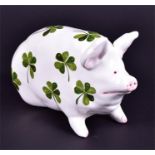 A Wemyss seated pig decorated in the clover leaf pattern  with highlighted painted facial and