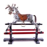 An Edwardian painted rocking horse on a blackened swinging frame, the dappled grey mount adorned