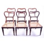 A set of six Regency single dining chairs with carved open backs, and cane seats, supported on