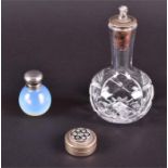 A white metal-mounted opalescent scent bottle of circular form, 4.8 cm high; a cut-glass scent