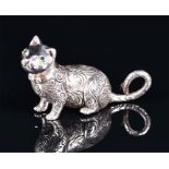 A novelty sterling silver figure of a cat with engraved decoration and green eyes, 2.7 cm high.
