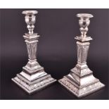 A pair of Continental silver candlesticks, 835 standard each central tapering column on a stepped