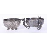 Two 20th century Chinese silver bowls, the larger with embossed decoration of natural scenes and