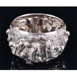 A Burmese silver cylindrical bowl with detailed repousse decoration to the border depicting