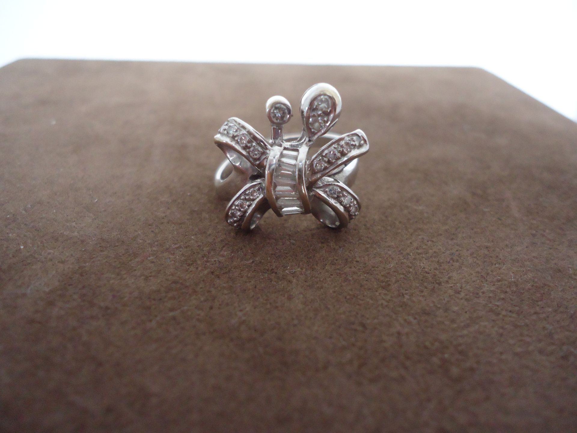 Butterfly shaped ring with round brilliant cut diamonds and baguettes diamonds. 18k white gold.