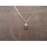 Pear shaped garnet pendant with 3 diamonds on 17'' gold chain. 18k yellow gold. Weight 4.5 grams