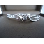 Wave design Bangle with hinge opening Center stone approx.: 0.45 CT. Total diamond weight of side