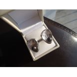 14k brushed white gold. 3 diamonds and a black tahitian pearl per cufflink.Measures 1X1.1 inch.Total