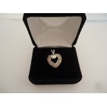 Delicate diamond heart pendant in 14k white gold. Approx. 55 diamonds Approx. diamond carat