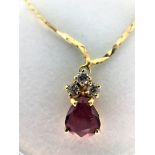 Pear shaped garnet pendant with 3 diamonds on 17'' gold chain. 18k yellow gold. Weight 4.5 grams