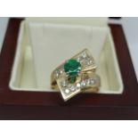 14k yellow gold Ring with 14 round brilliant cut diamonds and a big Emerald stone in the center.