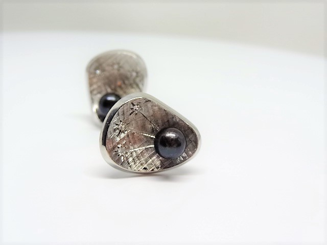 14k brushed white gold. 3 diamonds and a black tahitian pearl per cufflink.Measures 1X1.1 inch.Total