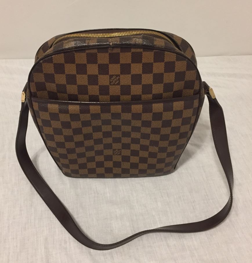 Authentic Louis Vuitton Ipanema GM shoulder bag in brown Damier canvas. Top is secured with double