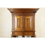 Djatiwooden colonial cabinet with carved corners en lion heads, two doors en two drawers, Indonesie,