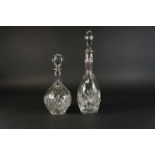 Lot van 2 kristallen karaffen onder stop met zilveren montuur, h. 29 en 39 cm. Lot of 2 crystal