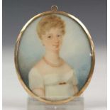 Ovale portretminiatuur op ivoor, ca. 1800; Dame met witte jurk, de achtzijde met haarstukje. In