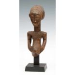 DRC., Hemba, wooden torso, hair bound and with a cross shape at the back, hands on the belly, the