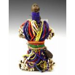 Cameroon, Fali, wooden doll, covered in stings of coloured beads, coins and kauri shells. h. 22