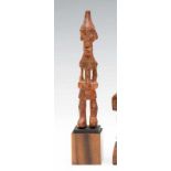 DRC, Benelulua, wooden figure, with enlarged eyes, conical head and painted in red. h. 15,5 cm. [1]