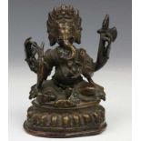 India, bronzen Ganesha, 19e eeuw, met attributen in de vier armen, op lotustroon, met ziel h. 11 cm.