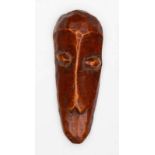 DRC., Lega, ivory mask, with a long nose with W-shaped nostrils, oval eyes with remnants of red